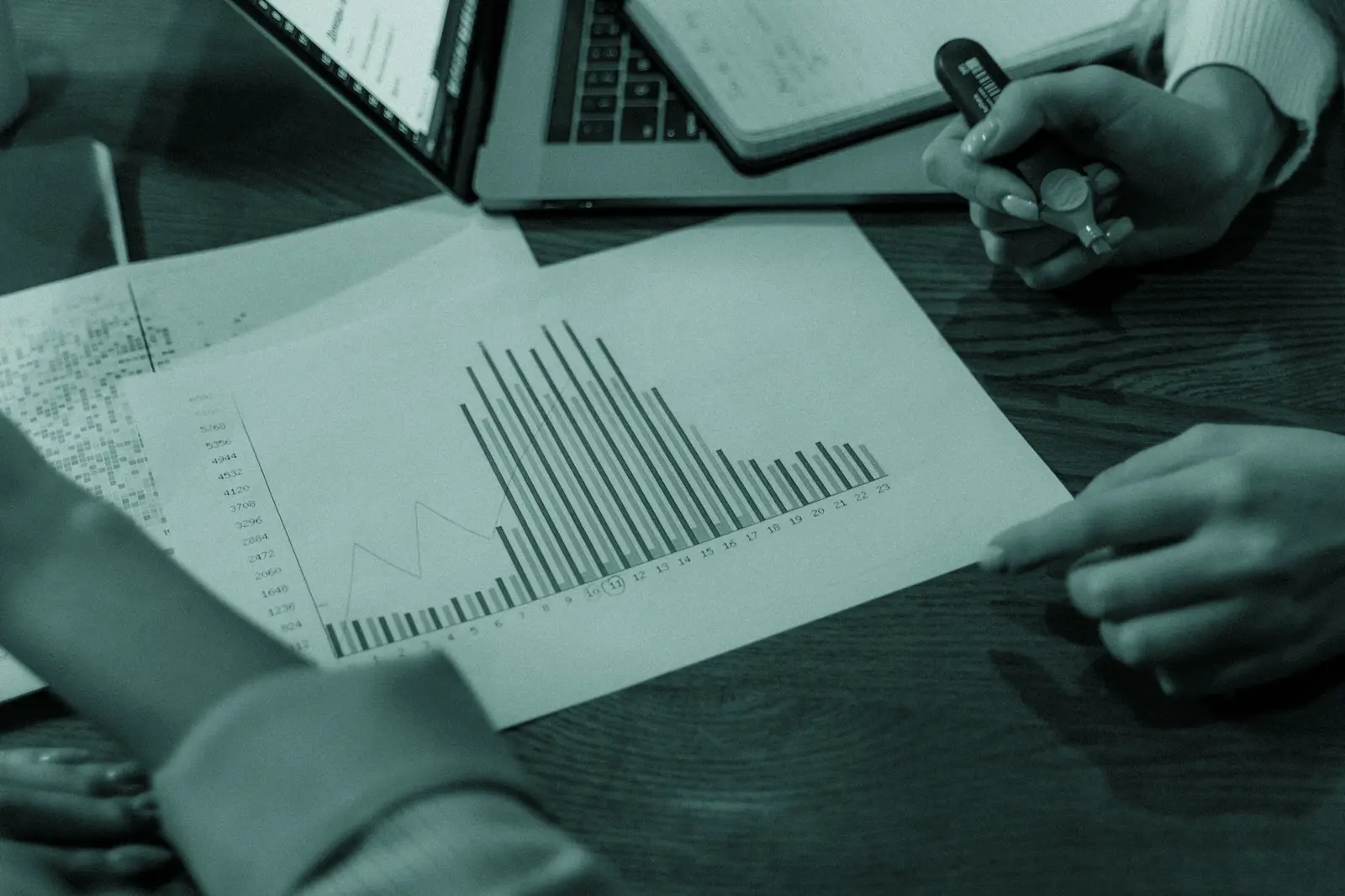Close-up view of colleagues discussing business reports in a creative office setting.