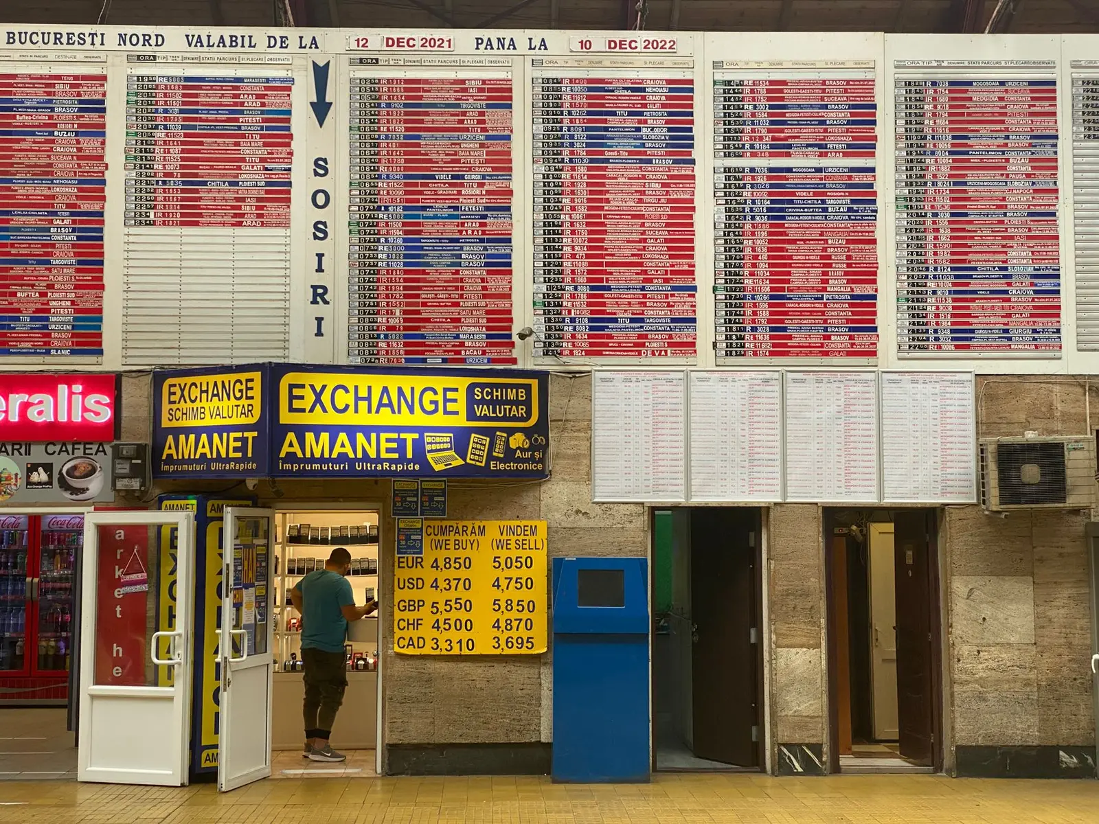 Currency exchange booth at Bucharest North Train Station with timetable overview.